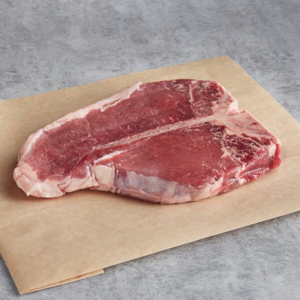 Warrington Farm Meats 12 oz. Frozen Porterhouse Steak - 14/Case