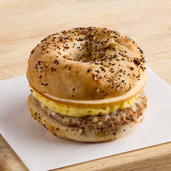 Grand Prairie Spicy Sausage, Egg, and Gouda Everything Bagel Sandwich 5.2 oz. - 24/Case