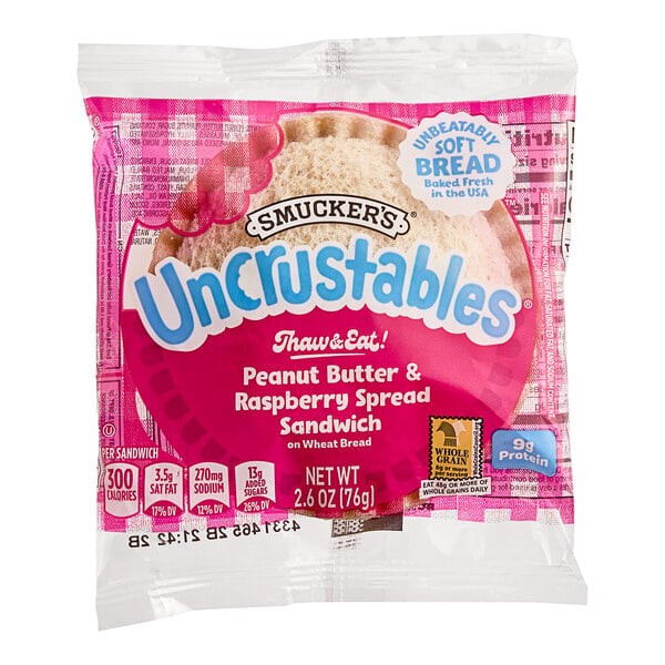 Smucker's Uncrustables Raspberry Spread and Peanut Butter Whole Wheat Sandwich 2.6 oz. - 72/Case