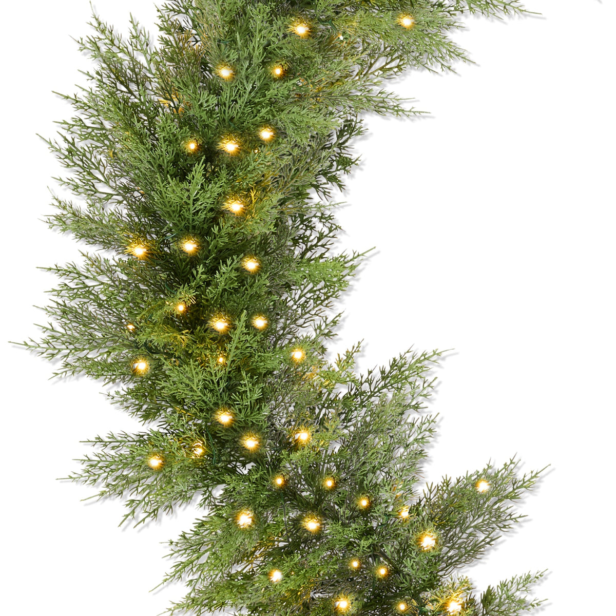 Pre-lit cedar cypress Christmas garland with twinkling LED lights draped over a mantel