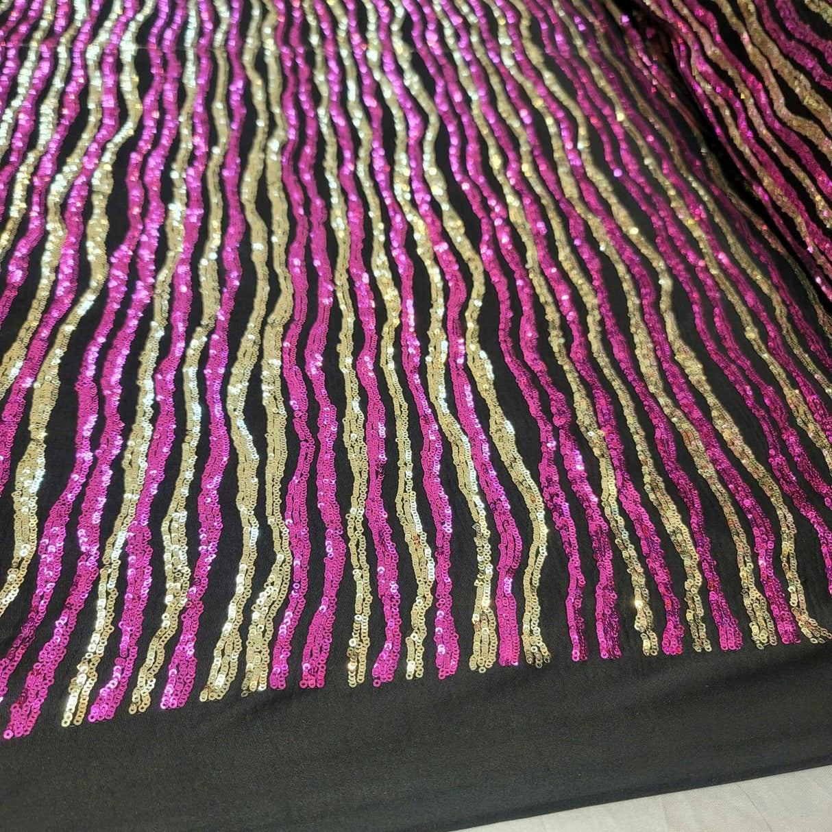 Sequin Fabric on Black Jersey Knit Gold and Fuchsia