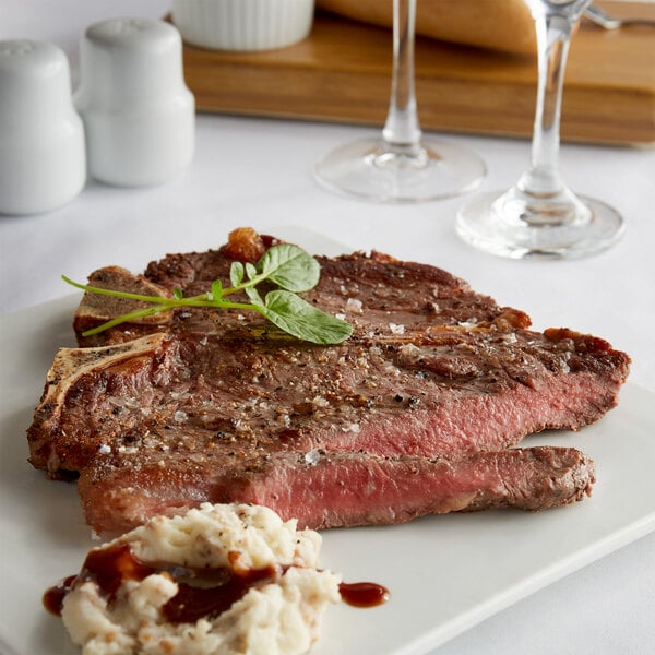 Warrington Farm Meats 12 oz. Frozen Porterhouse Steak - 14/Case