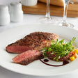 Warrington Farm Meats 8 oz. Frozen New York Strip Steak - 20/Case