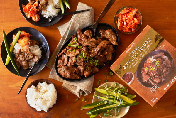 Korean beef bulgogi meal kit with prepared dishes on a wooden table