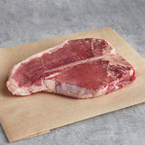 Warrington Farm Meats 12 oz. Frozen Porterhouse Steak - 14/Case