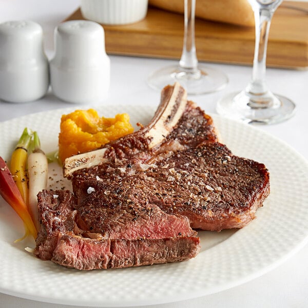 Warrington Farm Meats 14 oz. Frozen Bone-In Ribeye Steak - 12/Case