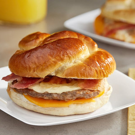 Grand Prairie Sausage, Bacon, and Cheese Pretzel Bun Sandwich 5.2 oz. - 24/Case
