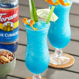 Torani Blue Curacao Flavoring Syrup 750 mL Glass Bottle - 12/Case