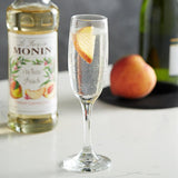 Monin Premium White Peach Flavoring / Fruit Syrup 750 mL - 12/Case