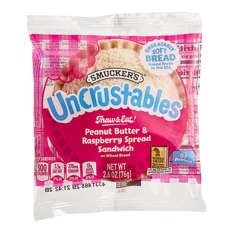 Smucker's Uncrustables Raspberry Spread and Peanut Butter Whole Wheat Sandwich 2.6 oz. - 72/Case