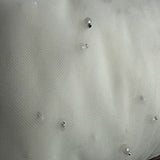 Polyester Mesh Fabric with Sewn Pearls White 52"