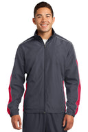 Chaqueta cortavientos colorblock con ribete Sport-Tek®.
