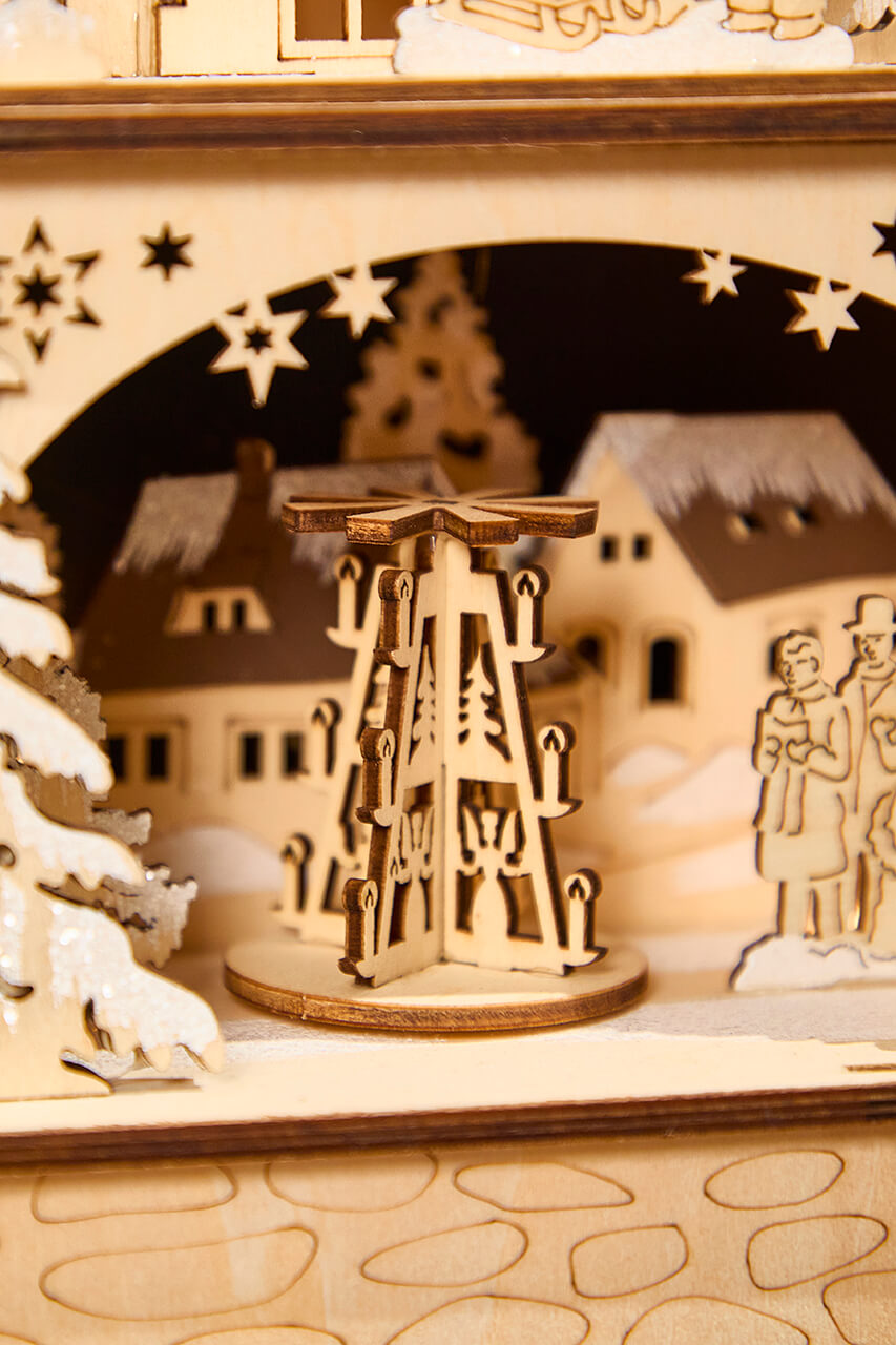 14.75" Lighted Laser Cut Wood Village Scene with Moving Figurine and Candles
