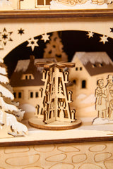 14.75" Lighted Laser Cut Wood Village Scene with Moving Figurine and Candles