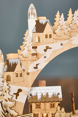14.75" Lighted Laser Cut Wood Village Scene with Moving Figurine and Candles