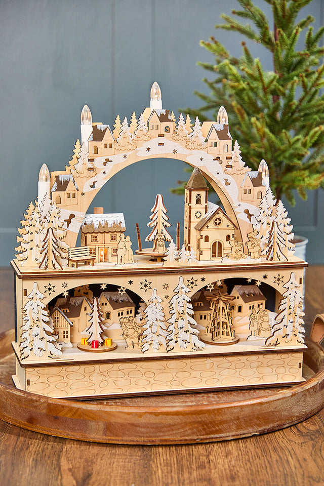 14.75" Lighted Laser Cut Wood Village Scene with Moving Figurine and Candles