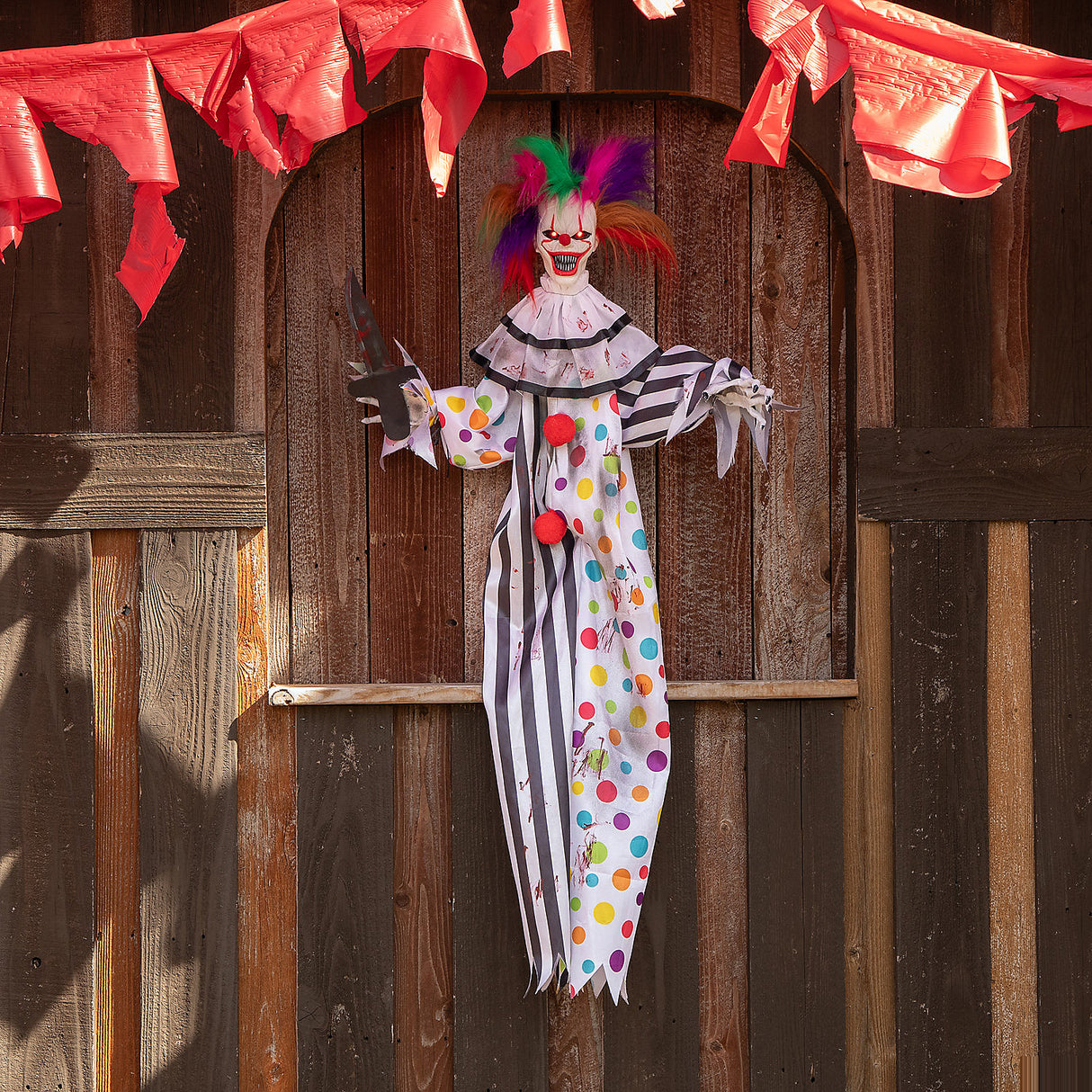 Spooky 4 Ft Hanging Animated Clown with Multicolored Hair for Halloween Decorations and Fright Night Fun