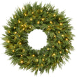 Pre-lit cedar cypress Christmas wreath glowing with twinkling LED lights on front door