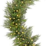 Pre-lit cedar cypress Christmas garland with twinkling LED lights draped over a mantel
