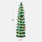 Hand-painted ceramic Christmas tree with glowing LED lights displayed as mantel decor