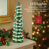 Hand-painted ceramic Christmas tree with glowing LED lights displayed as mantel decor