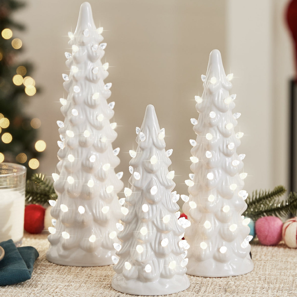 Set of XL pre-lit ceramic tabletop Christmas trees with LED lights displayed together