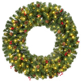 Pre-lit artificial Christmas wreath decorated with berries and pinecones on a wooden door