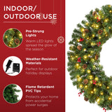 Pre-lit artificial Christmas wreath decorated with berries and pinecones on a wooden door