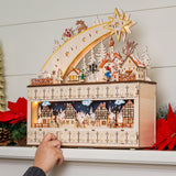 Wooden shooting star Christmas advent calendar with warm LED light hanging on a festive wall display