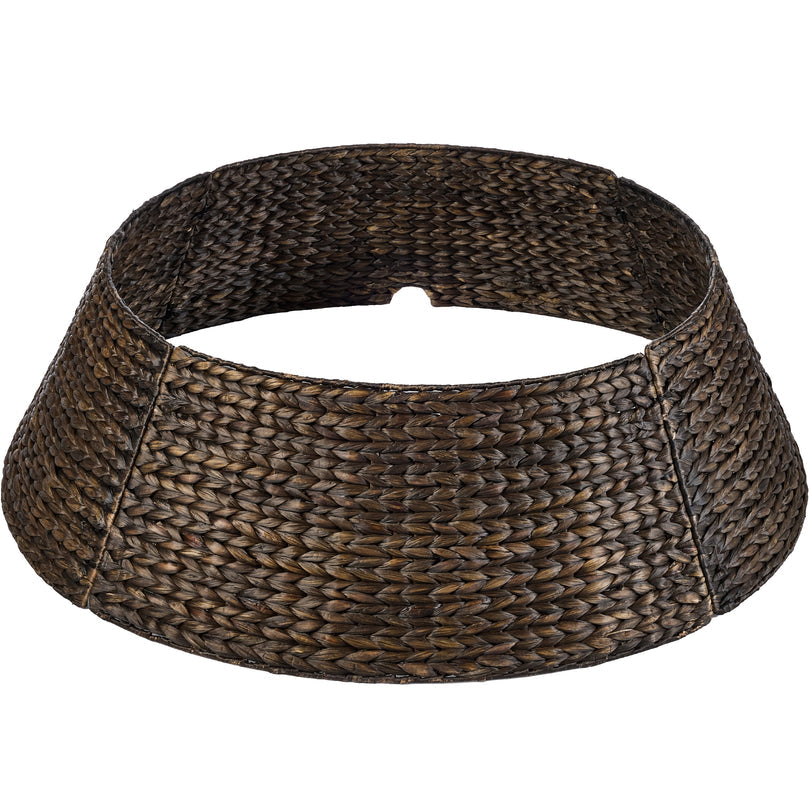 Handwoven hyacinth Christmas tree collar with braided design wrapped around a tree base