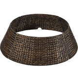 Handwoven hyacinth Christmas tree collar with braided design wrapped around a tree base