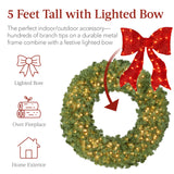 Pre-lit artificial fir Christmas wreath with decorative bow and glowing LED lights on display
