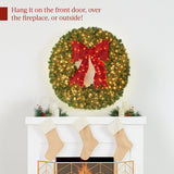 Pre-lit artificial fir Christmas wreath with decorative bow and glowing LED lights on display
