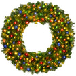 Pre-lit artificial fir Christmas wreath glowing with multicolor LED lights on a wooden door