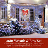 Pre-lit outdoor Christmas wreath with glowing LED lights and a festive bow on front door