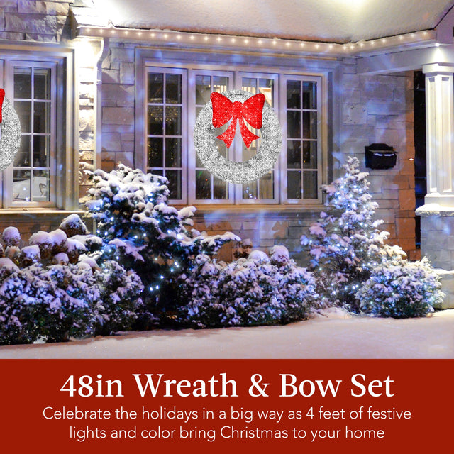 Pre-lit outdoor Christmas wreath decorated with LED lights and a decorative red bow on entry door